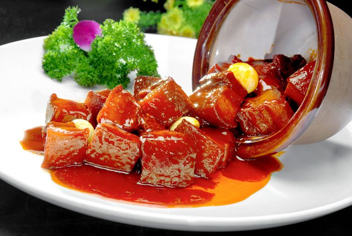 Mao-style red-braised pork, with glossy sauce and tender pork belly, is a well-known Hunan dish.