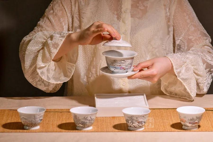 A gaiwan and small tea cups used in a carefully prepared Chinese tea ceremony.