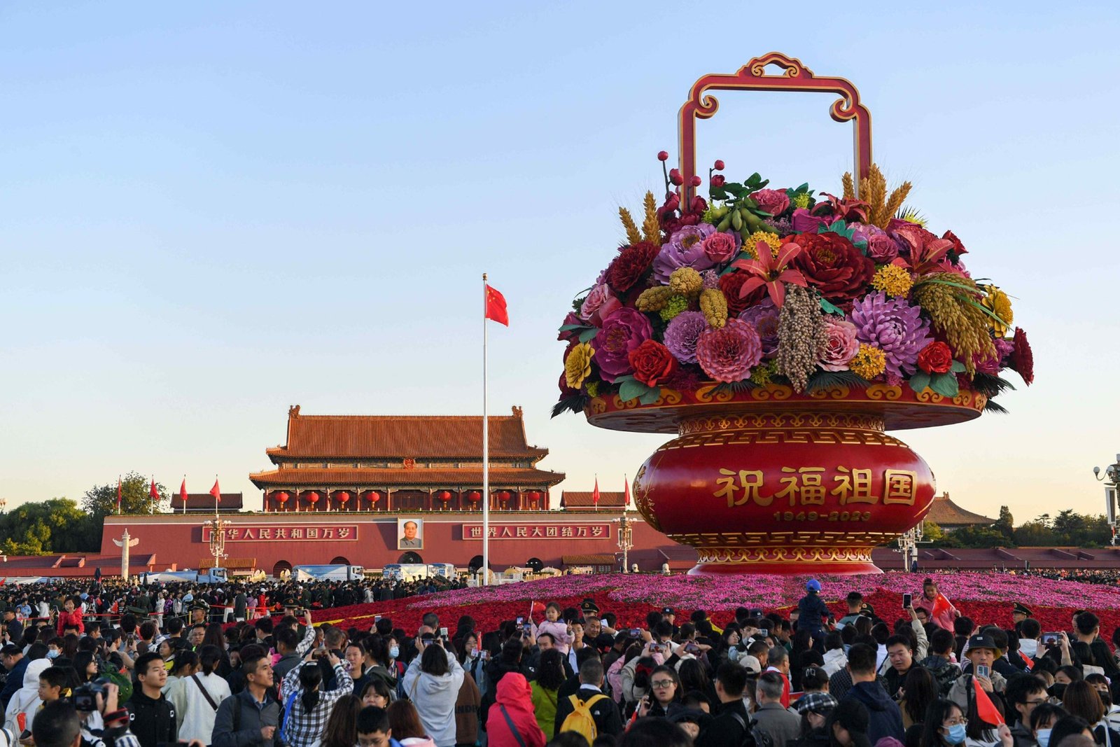 Visitors gather around the National Day floral display in Tiananmen Square in 2023.