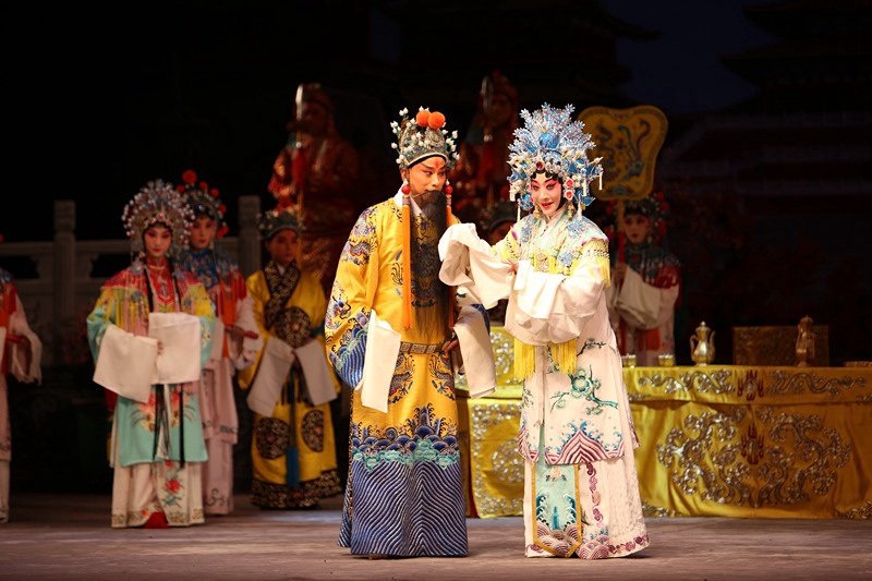Peking opera performers in embroidered costumes on the stage of Mei Lanfang Grand Theatre.