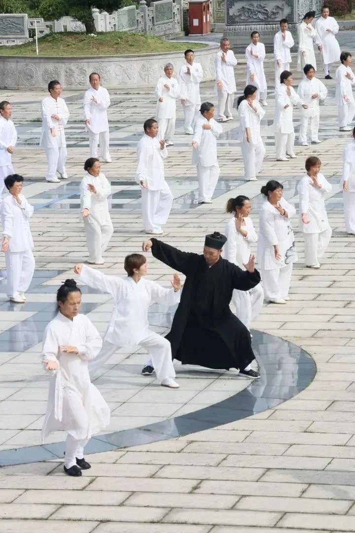 An instructor guides a group through tai chi at Taiji Temple in Guizhou