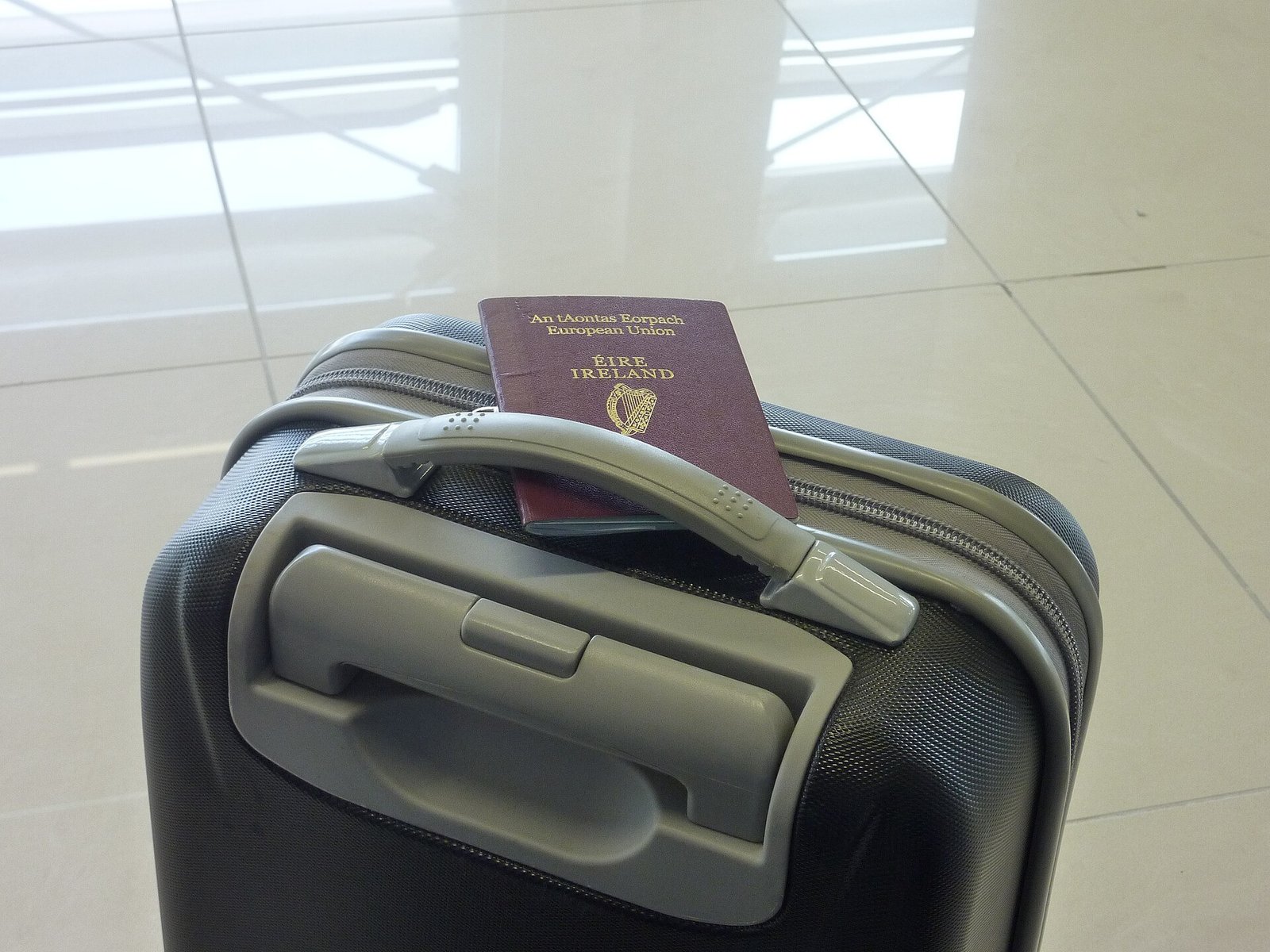 A passport resting on travel luggage.