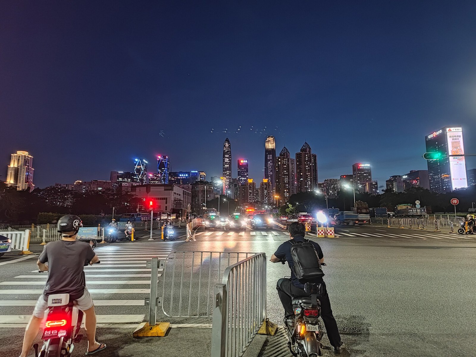 Shenzhen’s Futian skyline seen from a street at night.